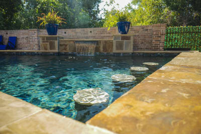 Multi-zone outdoor living space crafted by Selah Pools featuring water features and hardscape integration at a Tarrant County estate in Arlington, TX.