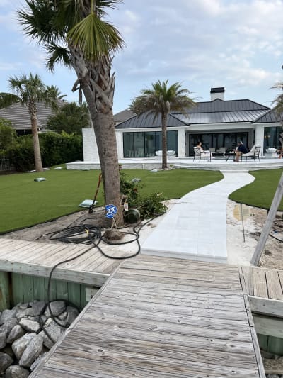 Luxury pool with stone patio at the Sheldon Residence in Miramar Beach, FL, showcasing expert outdoor living design.