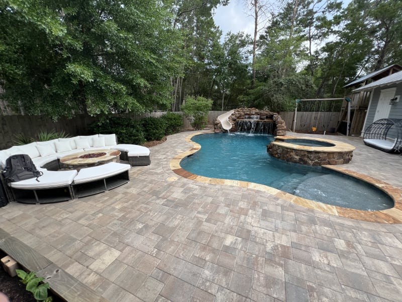 Luxury pool and spa outdoor living space at the Colon Residence in Santa Rosa Beach, FL, featuring a pool, spa, and landscaped patio.
