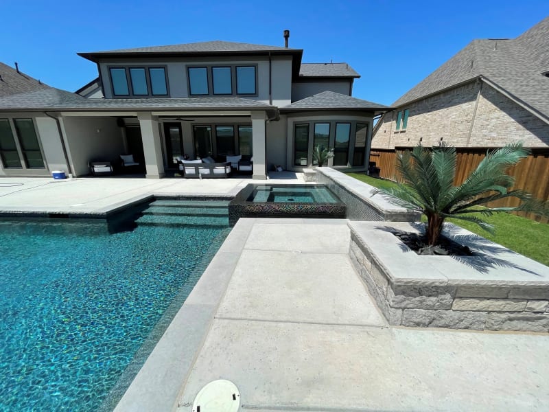Establishing overview of the Phillips family's complete outdoor environment taking shape on their Roanoke, Denton County, TX property, showcasing the architectural design-build transformation in progress.