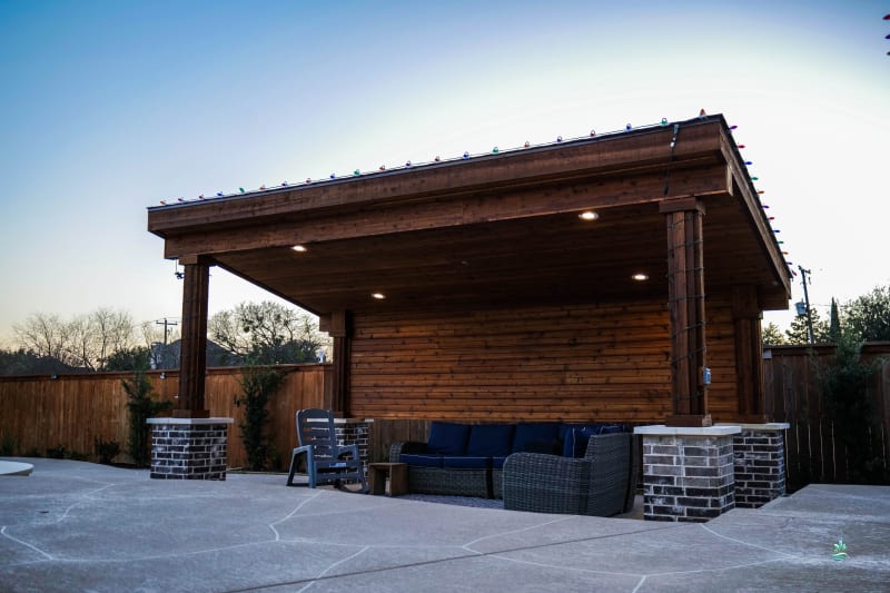 Gradual beach entry with stone and concrete steps transitioning from shallow to deep water at the Burrow residence resort-style pool in Mansfield, TX.
