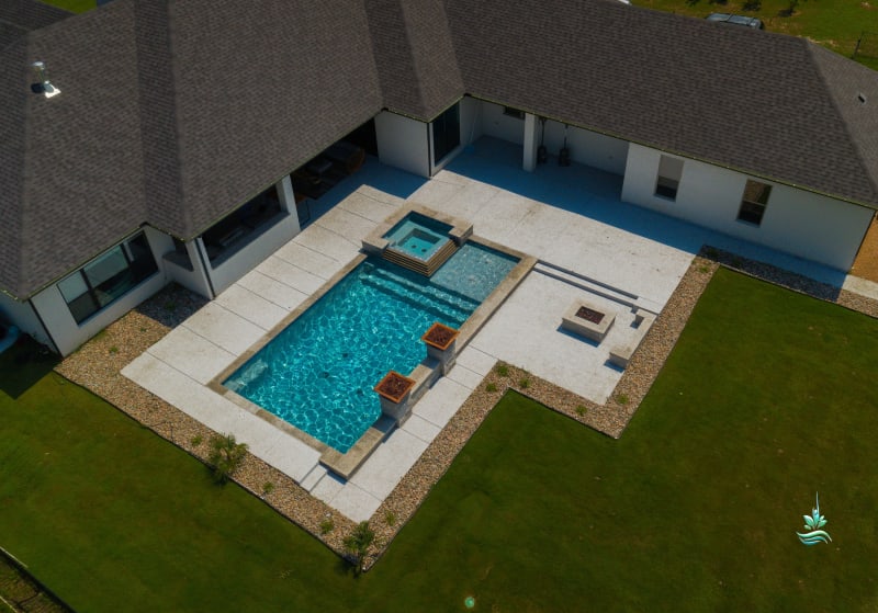 Custom pool with crystal-clear water and stone patio at the Carter Residence in Godley, Johnson County, TX, showcasing advanced automated filtration and intelligent cleaning systems for effortless family enjoyment.
