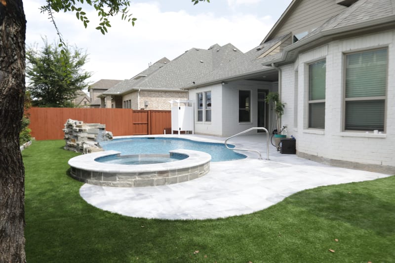 Naturalistic freeform pool with Silver Mist grotto, Burlington Armani Grey coping in Frisco, TX by Selah Pools