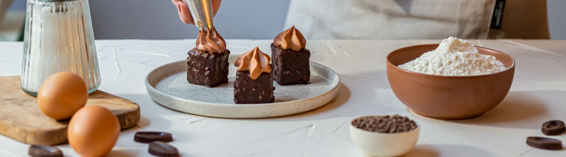 Home baker adding the last touch on chocolate cakes