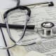 Stethoscope laying on top of a patient record