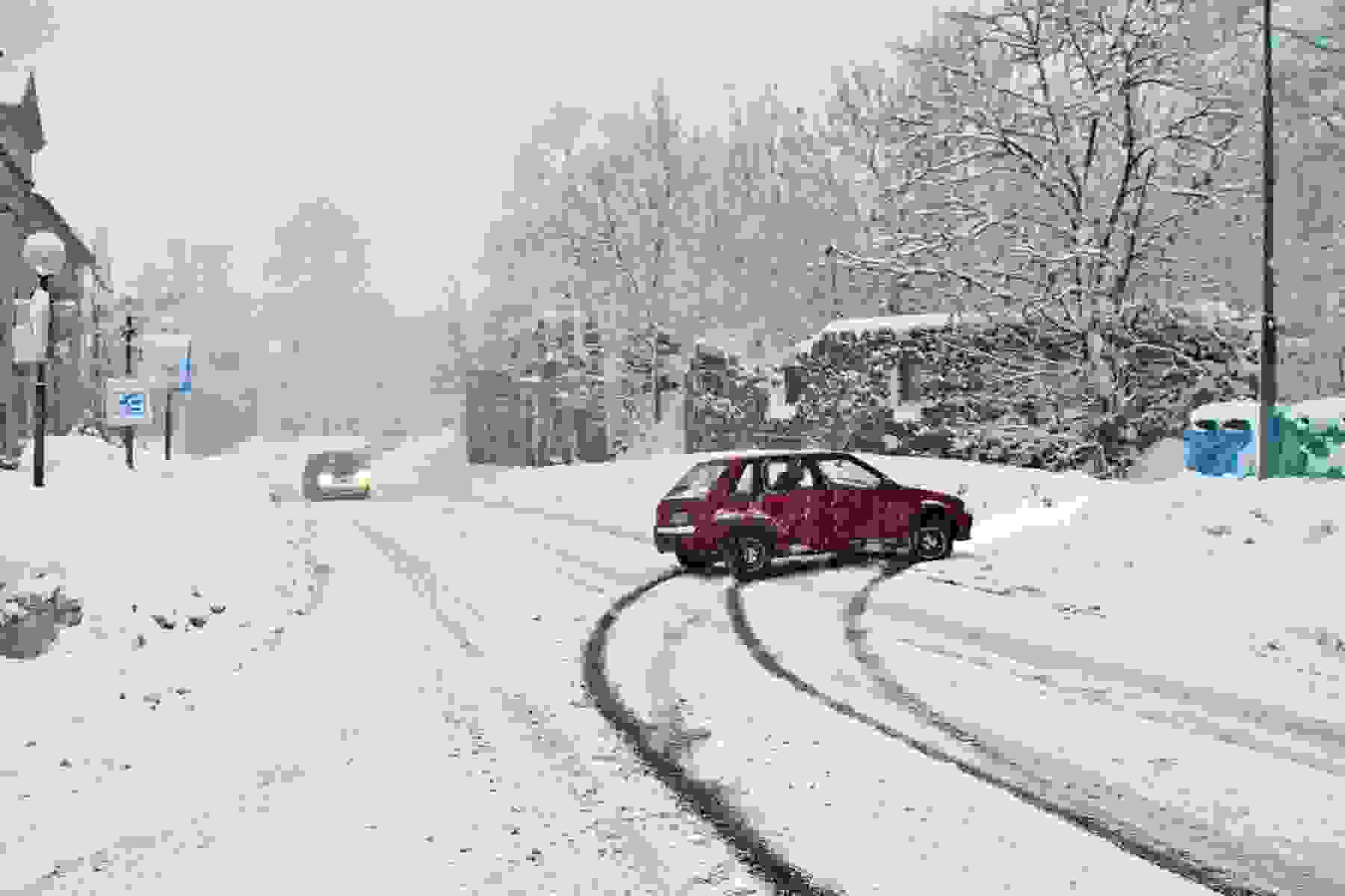 Car slides into snow bank