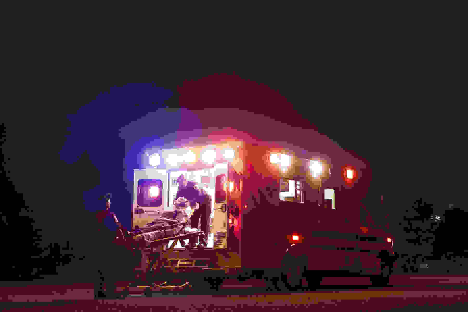 A woman being loaded into an ambulance.