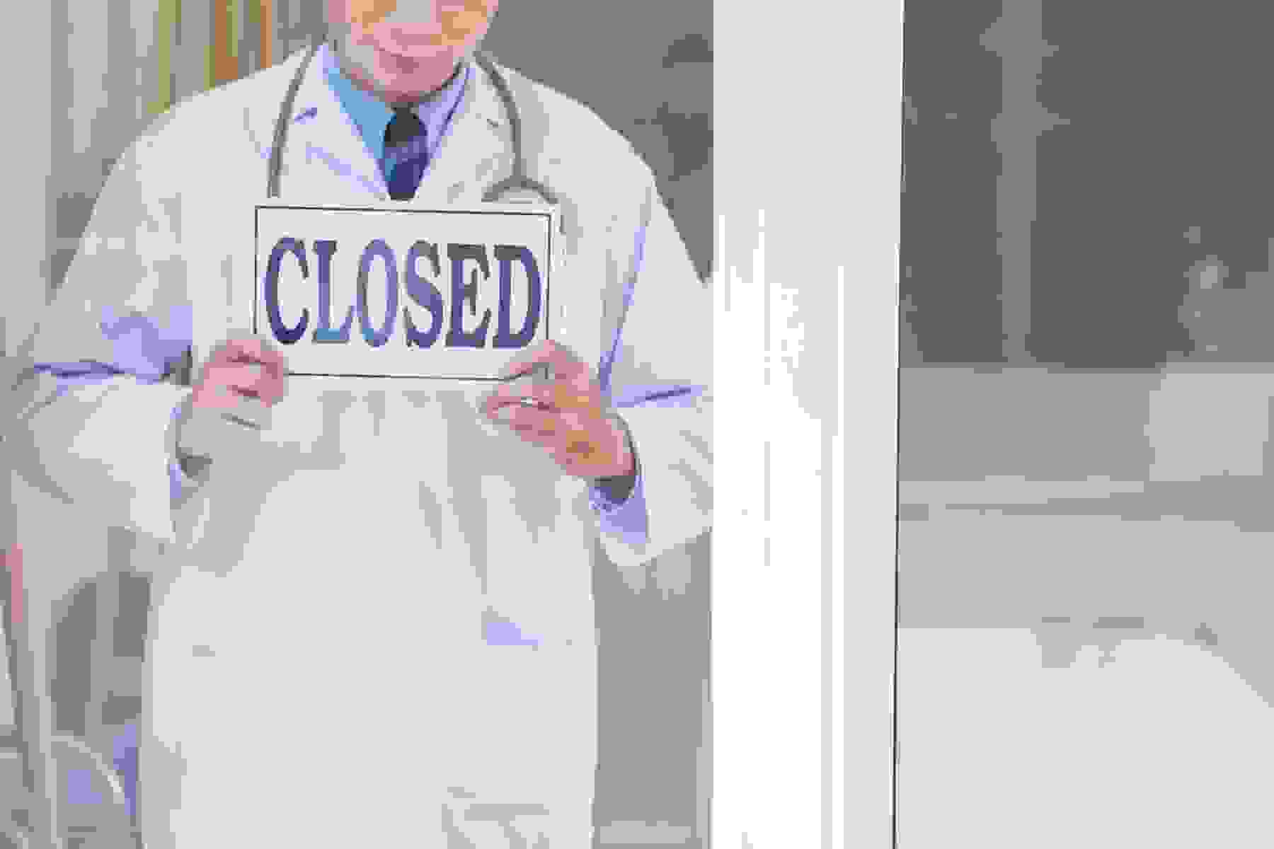 A pharmacist closing his store