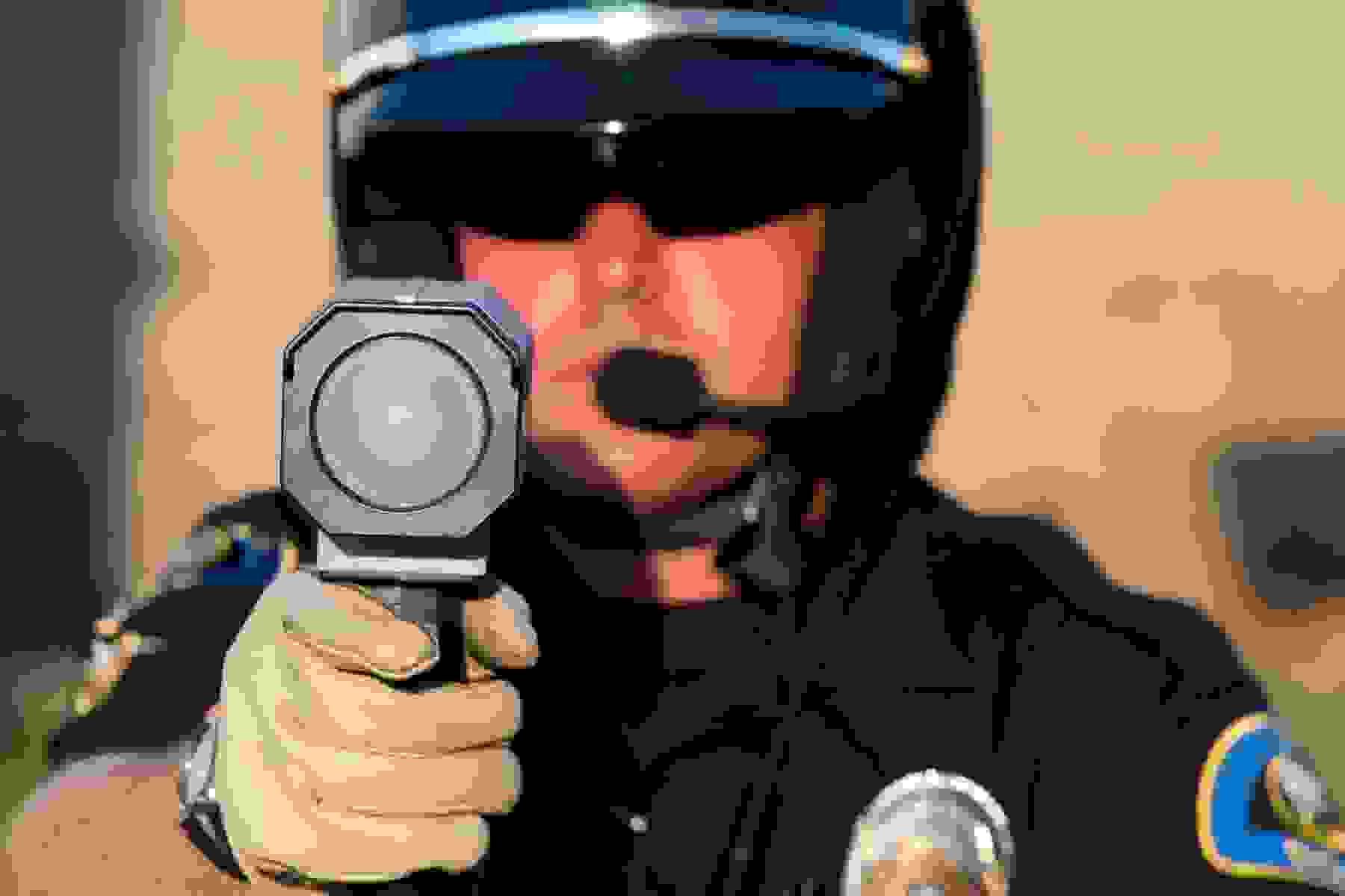 Officer using a speeding detection device.