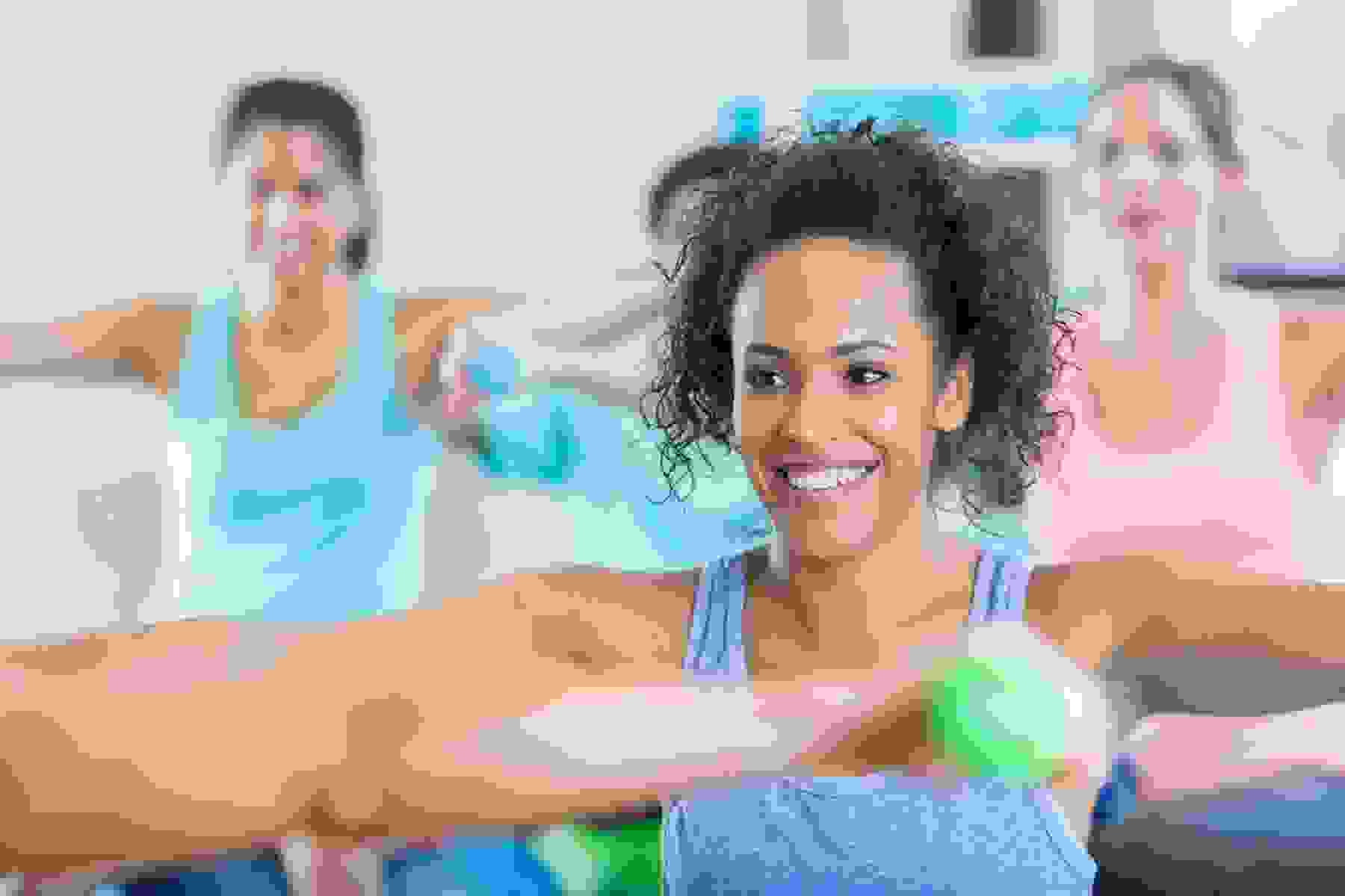 A woman participates in a weight training exercise class.