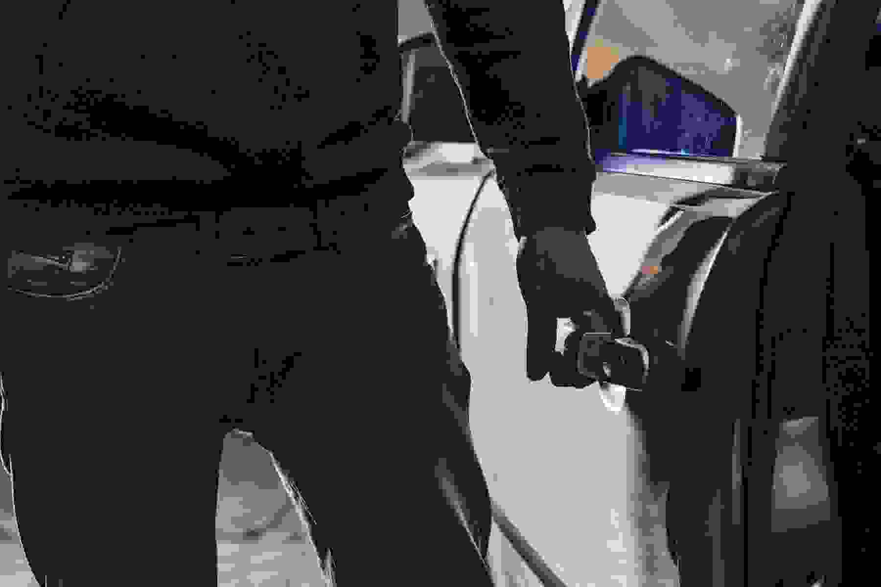 Man stealing a car at night