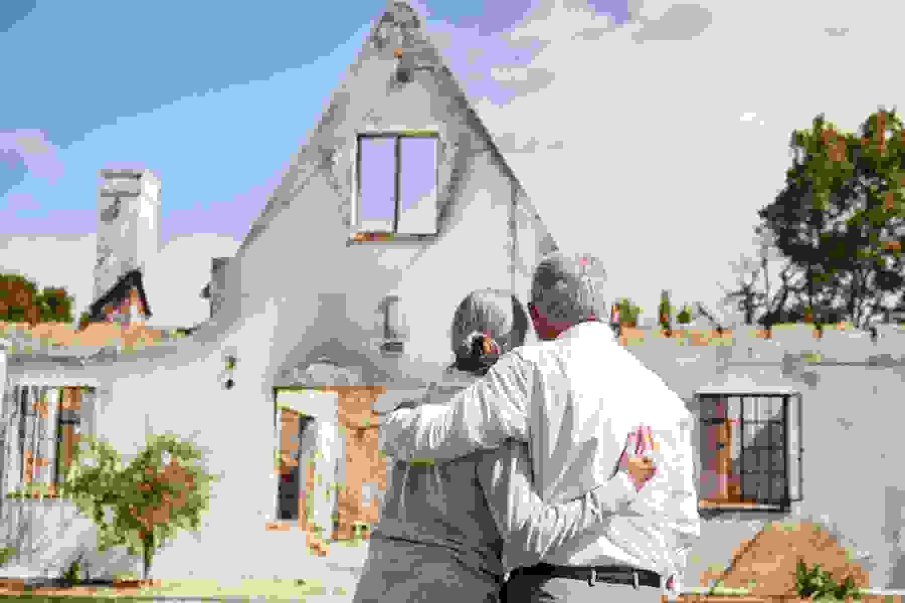 A couple looks at their damaged home.