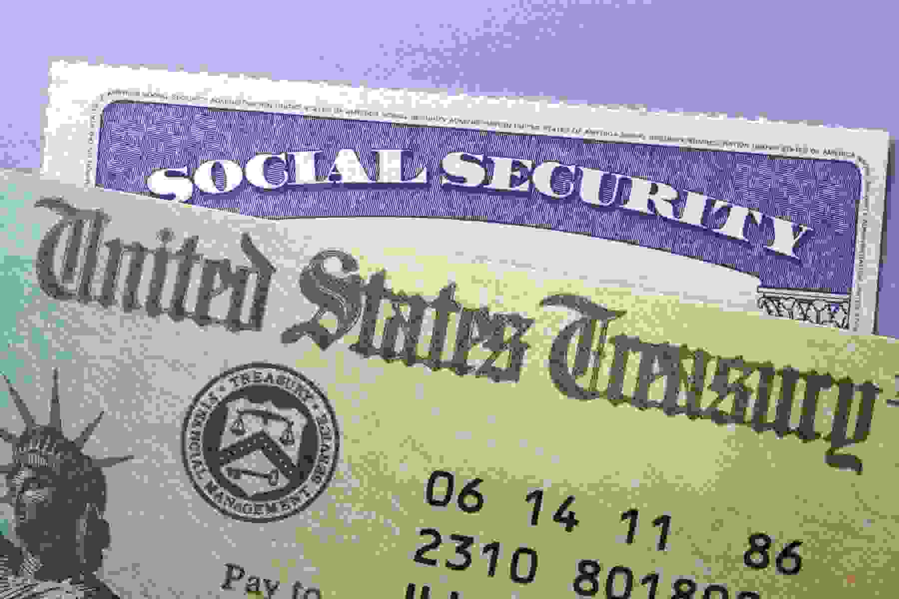 A United States Treasury check on top of a Social Security card