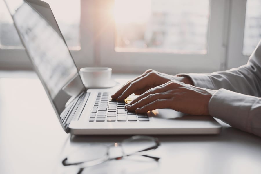 person typing business plan on laptop