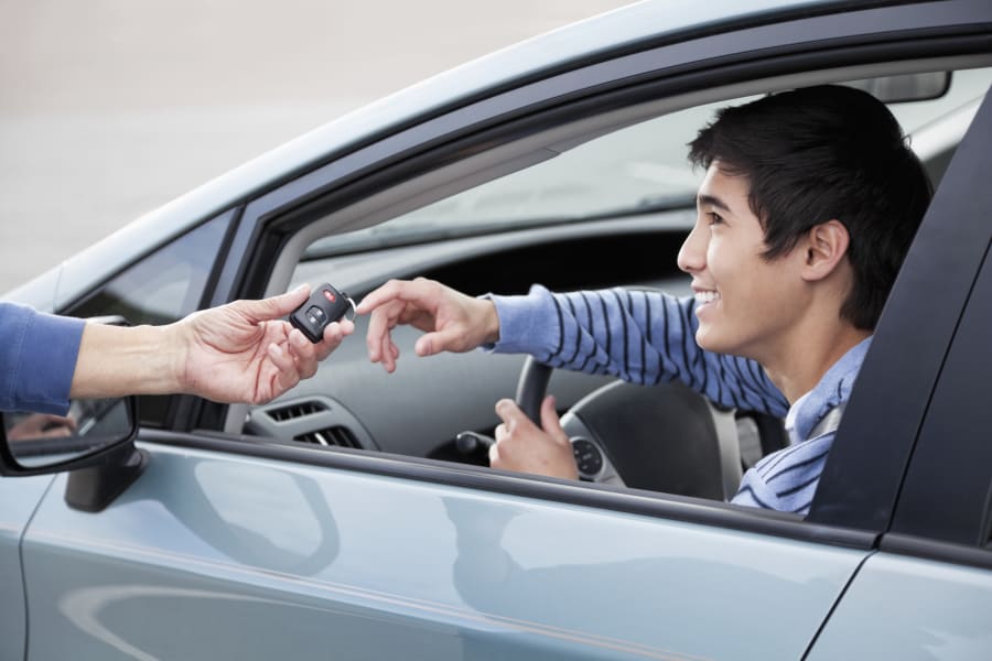 Woman handing man a key fob