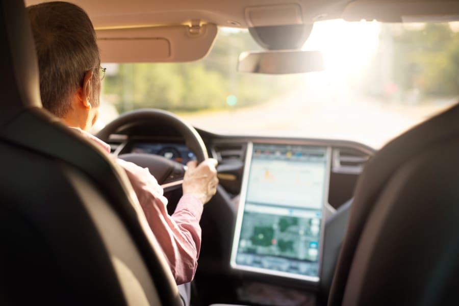 man driving a Tesla