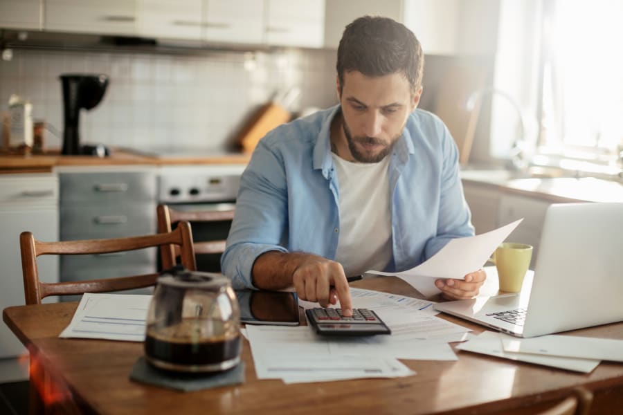 Man Calculating Personal Loan Interest