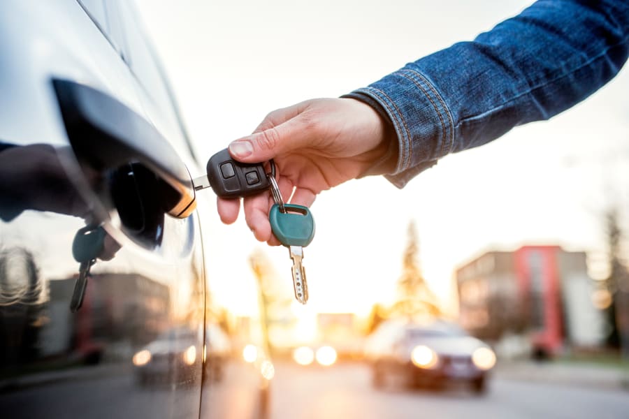 Driver unlocking car with keys