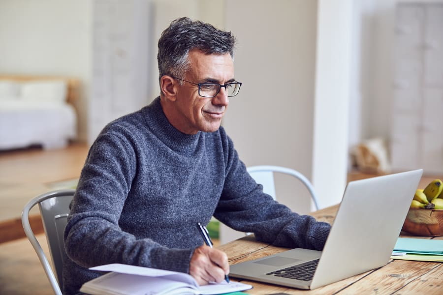 Shot of a handsome and mature businessman working from home