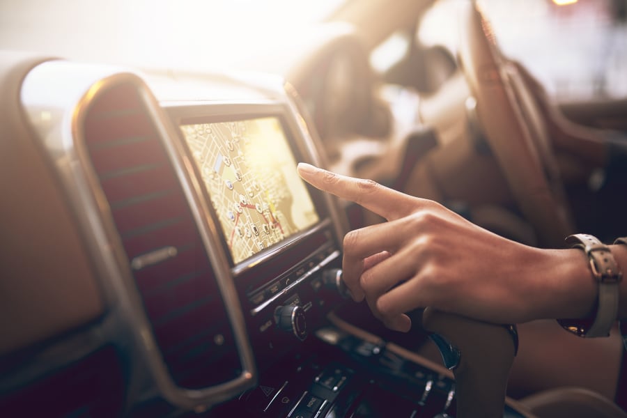 Woman touching navigation screen in car