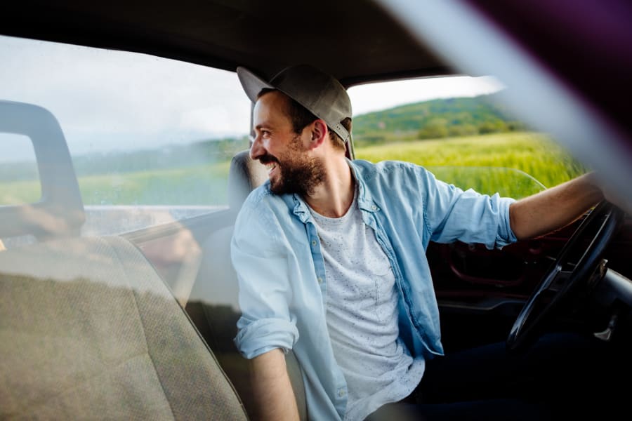 Young man driving on a farm