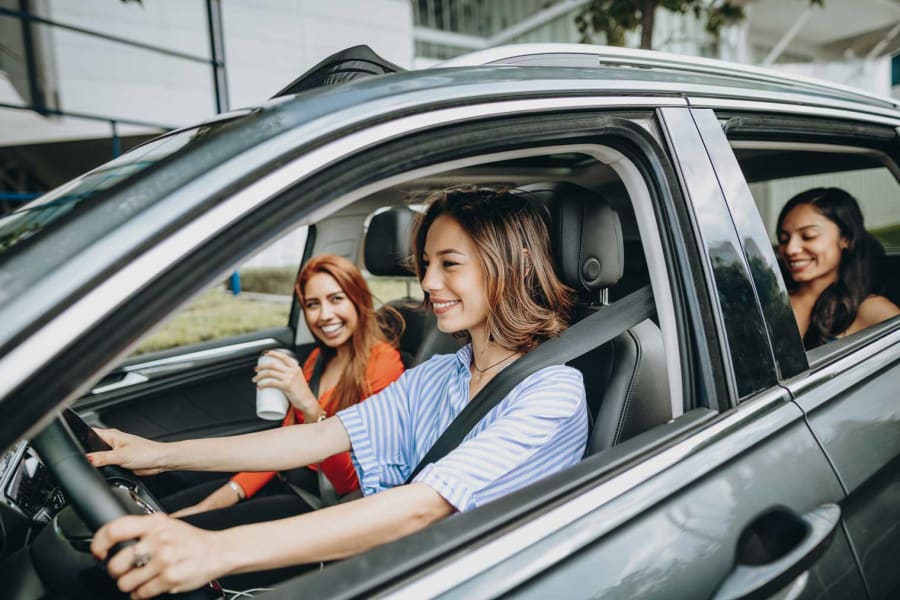 Friends sitting in the back of a car