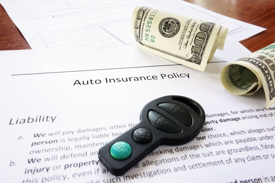 Car insurance policy with money and keys