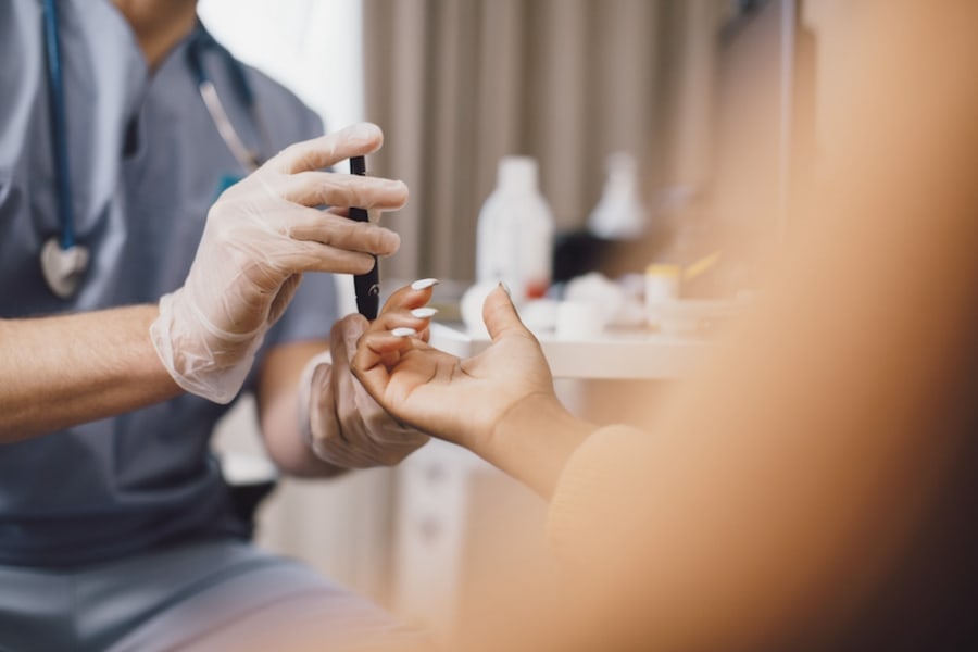 A doctor checks the blood sugar of his patient.
