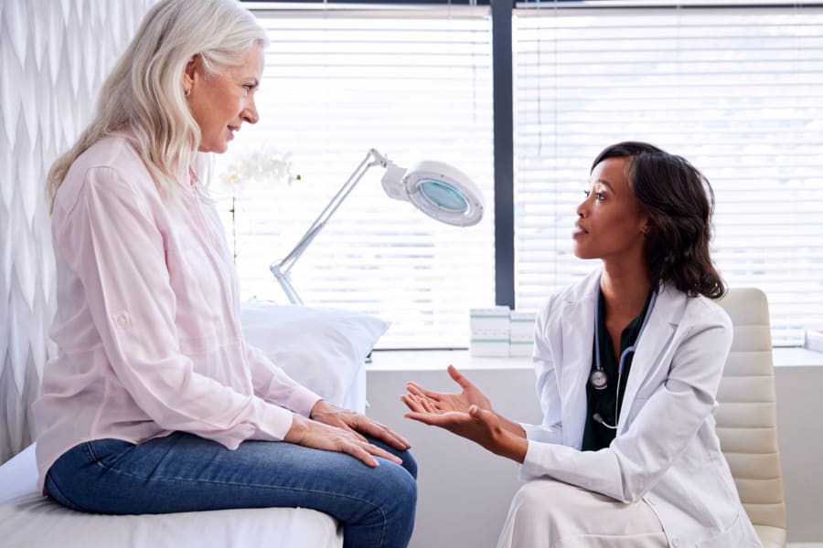 A doctor speaks to a patient.
