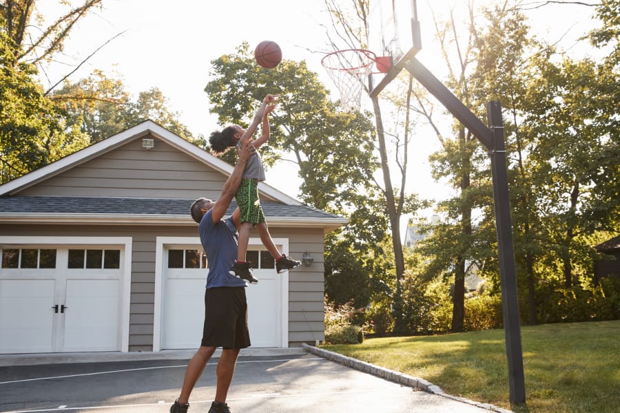Father and daughter playing basketball