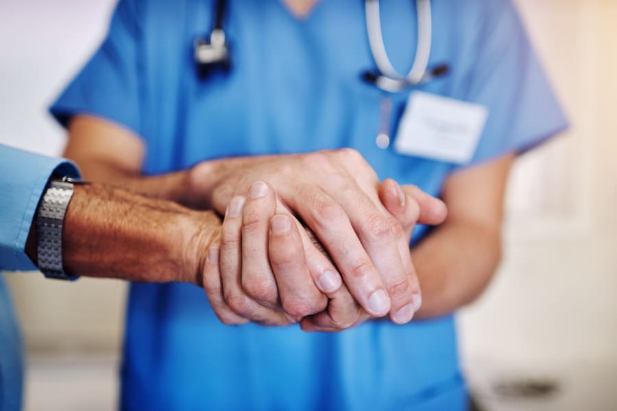 Doctor holding a patient's hand.
