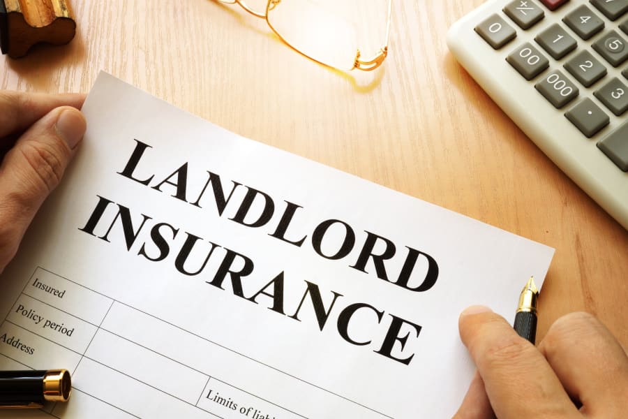 Signing a landlord insurance policy to protect rental income