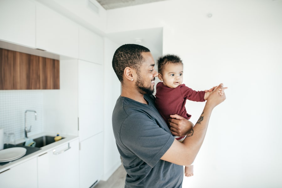 Father and newborn dancing.