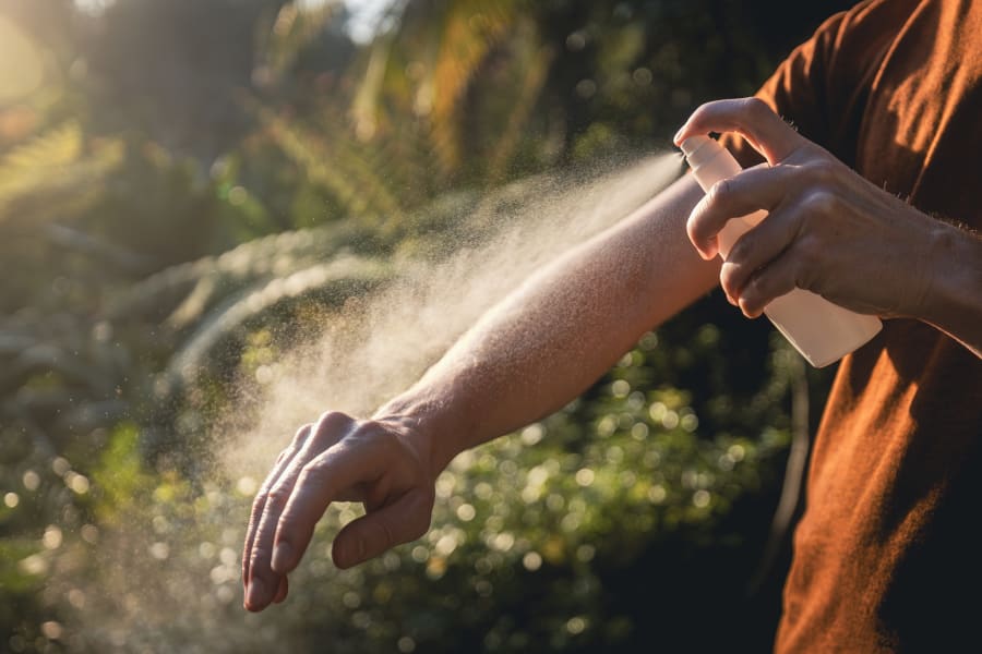 Man applying insect repellent