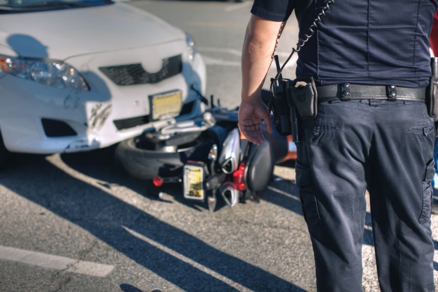 A first responder at the scene of a motorcycle accident.