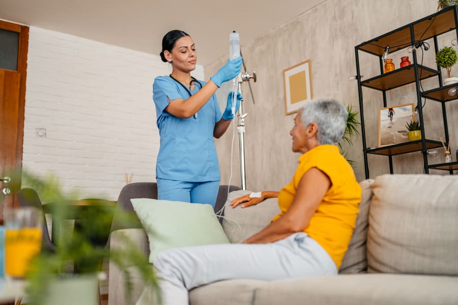 Home care nurse visiting senior woman