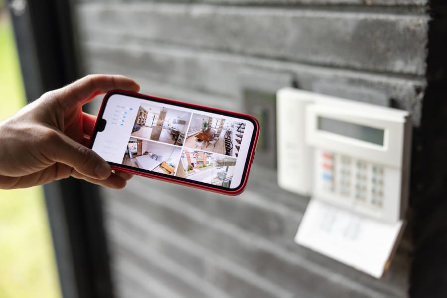 A woman watches the security cameras in her house.