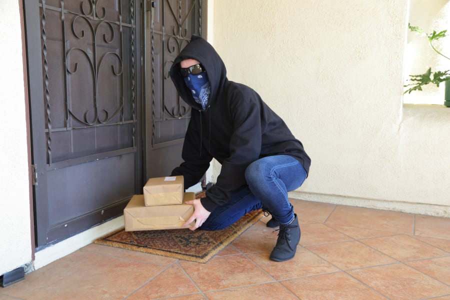 A porch pirate steals packages.