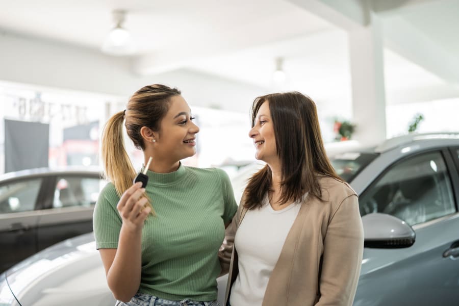 A mother and daughter purchase a used car.