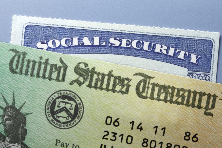 A United States Treasury check on top of a Social Security card