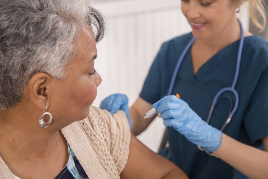 A nurse administers a flu vaccination.