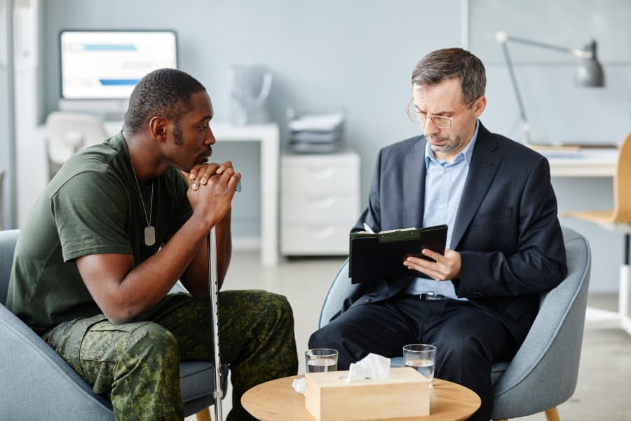 A veteran sitting with a doctor