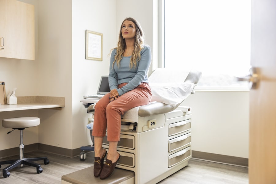 Young female patient waiting in doctor's exam room