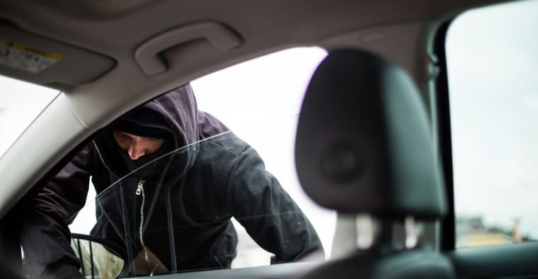 A man breaks into a car