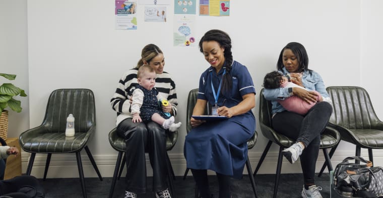 Mothers with their babies in a waiting room