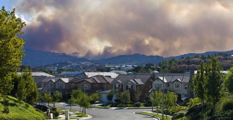Dense wildfire smoke over Los Angeles, CA suburban neighborhood