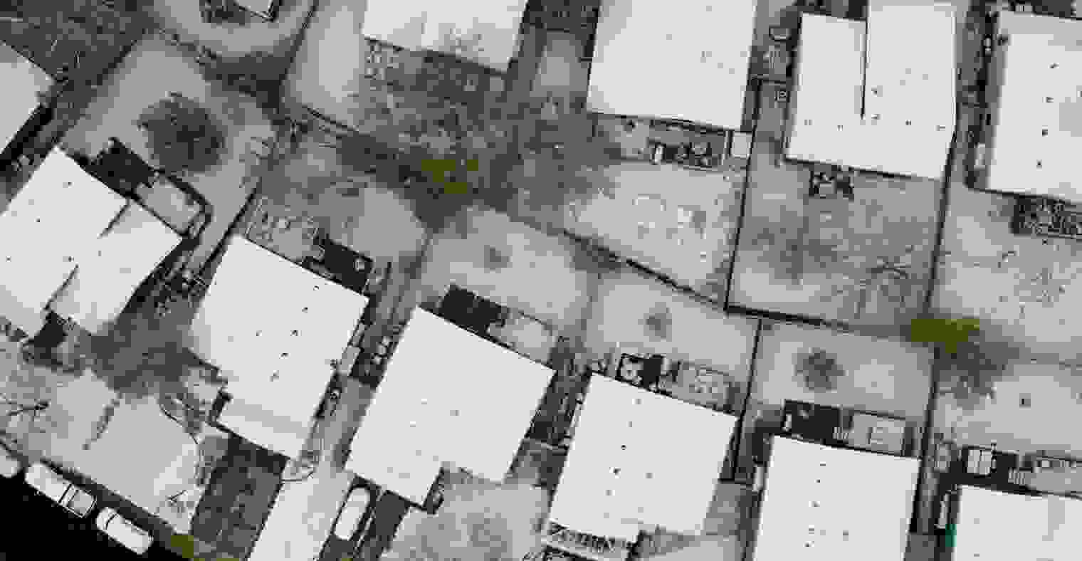 An aerial view of a snowy neighborhood