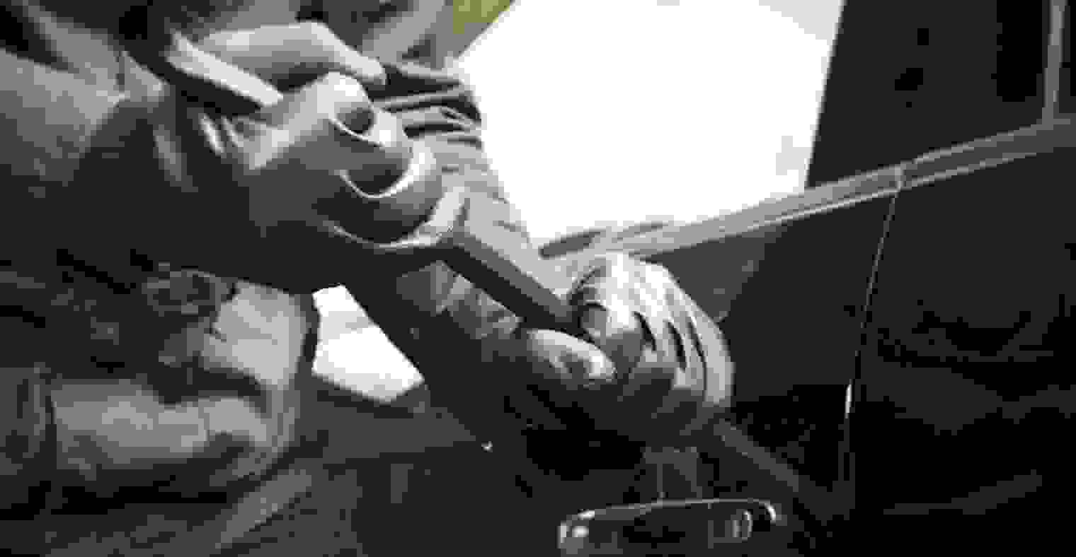 A person breaking into a car