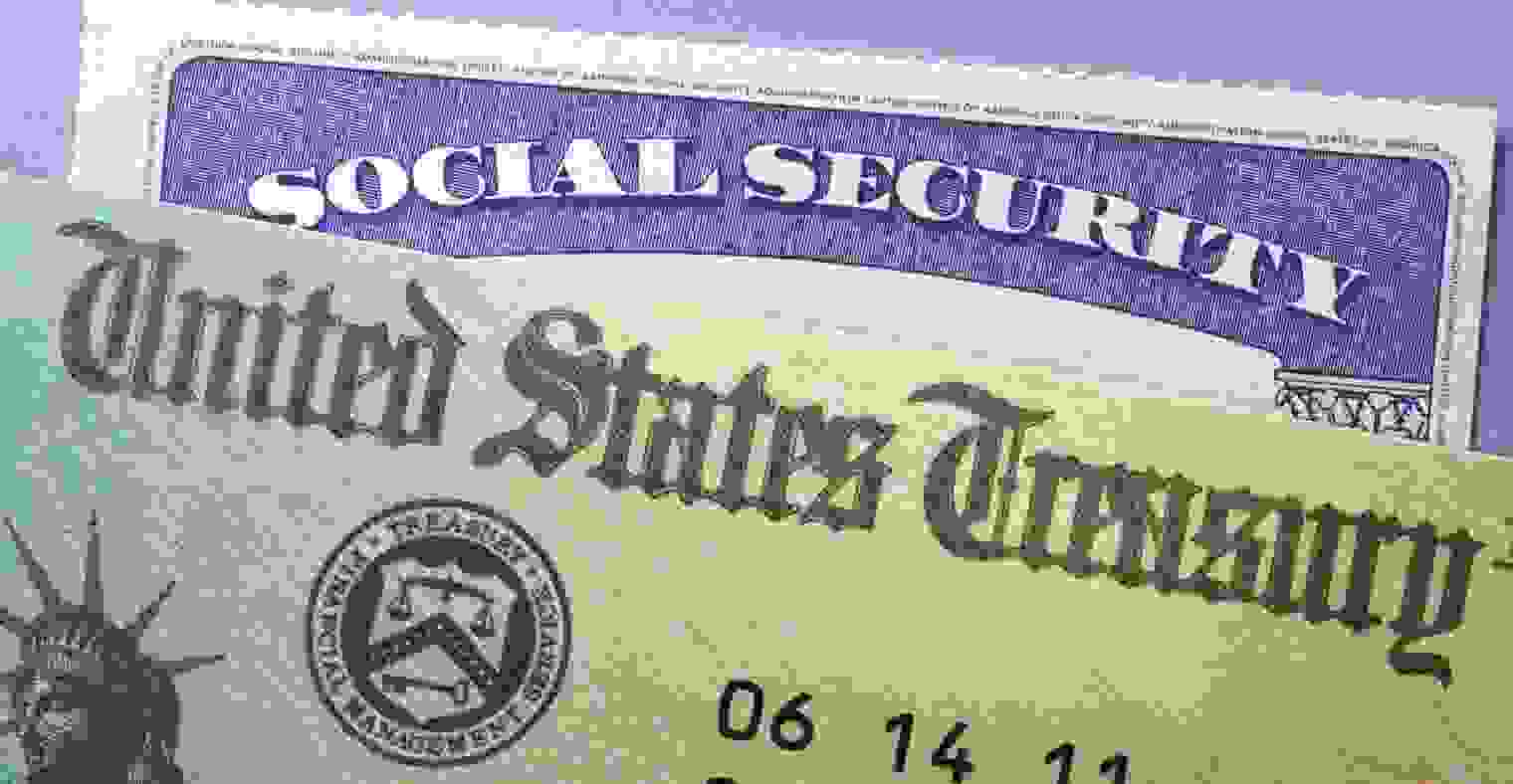 A United States Treasury check on top of a Social Security card