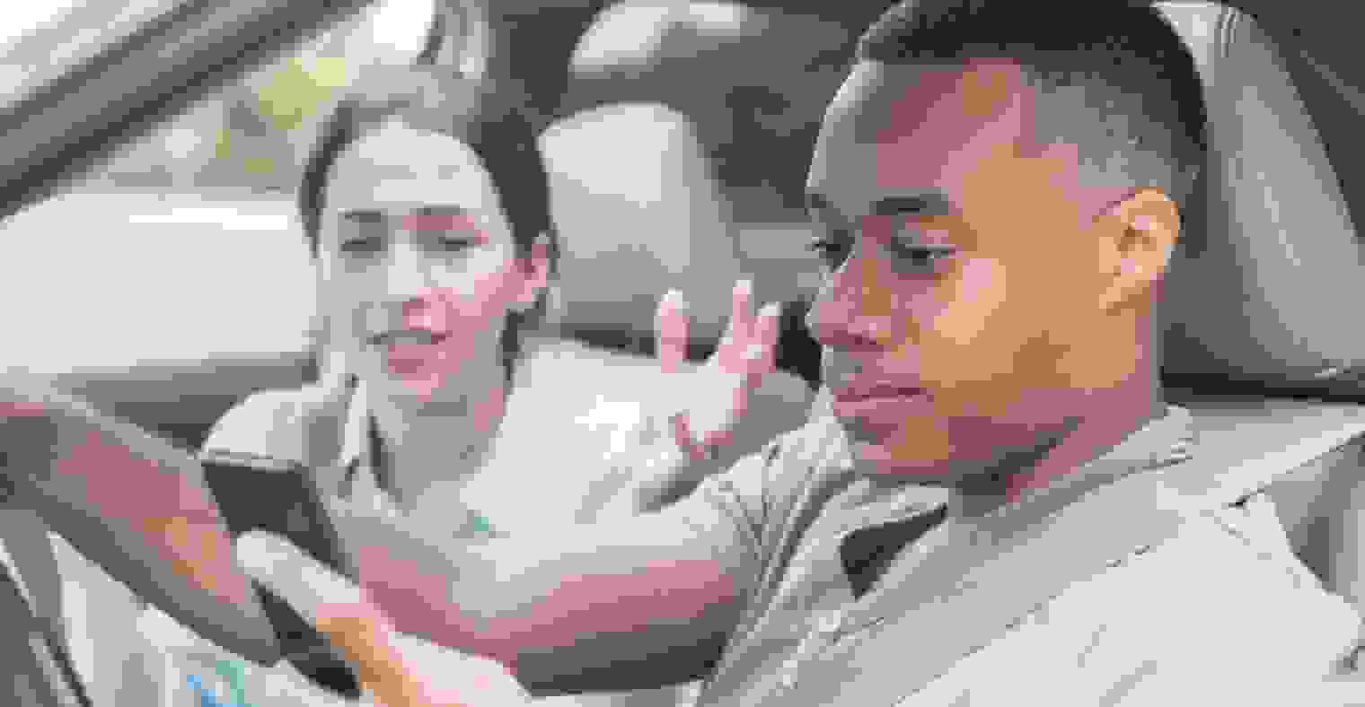 Couple in car on phone